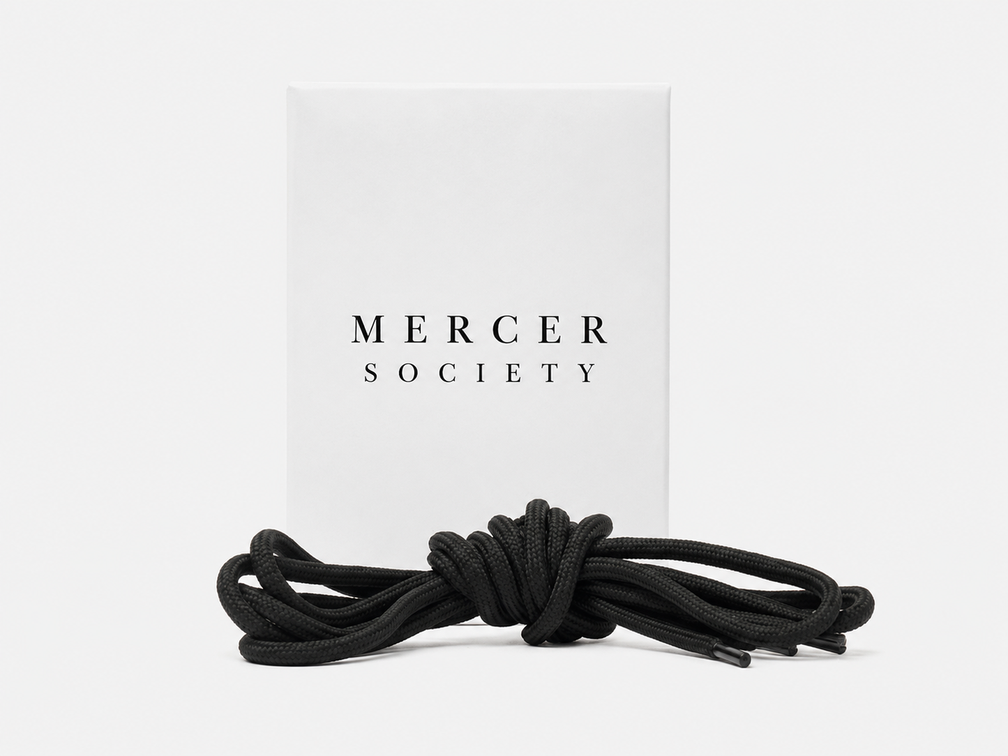 Black Mercer Society laces shown in close-up, featuring durable round design suitable for various footwear styles.