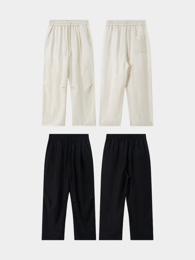 Black Mercer Society Drift Trousers shown flat, featuring a relaxed fit and stylish design for casual or smart casual wear.